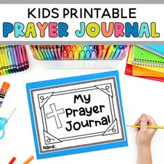 a child's hands holding a pencil over a paper with the words my prayer journal on it