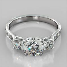 a three stone engagement ring with diamonds on the sides