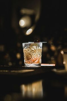 a glass filled with liquid sitting on top of a table