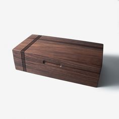 a wooden box sitting on top of a white surface