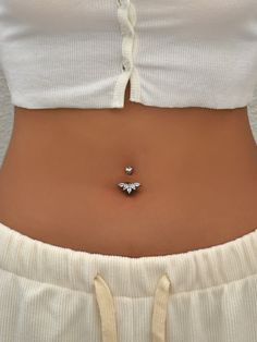 a woman's stomach with a bee pin in the middle of her belly,