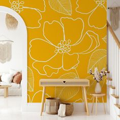 a yellow floral wallpaper with white flowers on it in a living room next to stairs