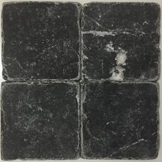 four square black tiles with white spots on the top and bottom, all in different sizes