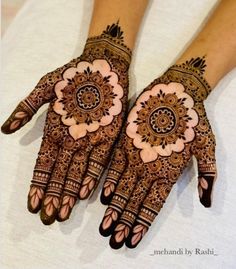 two hands with henna designs on them