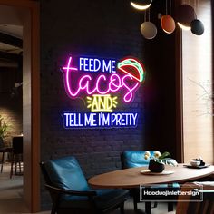 a neon sign that reads feed me tacos and tell me i'm pretty