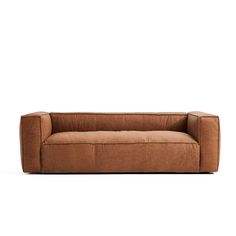 a brown couch sitting on top of a white floor