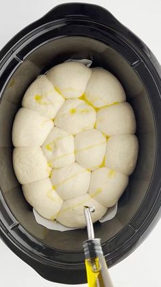 the buns are being cooked in an air fryer with oil and butter on top