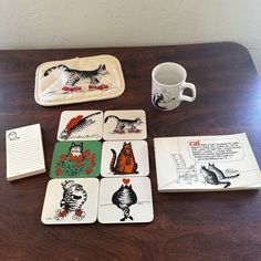 a wooden table topped with coasters and cards