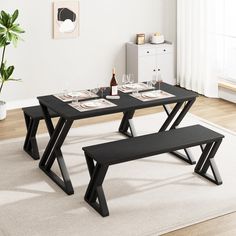 a black table with two benches in front of it and a white rug on the floor