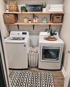 a washer and dryer in a small room with open shelving on the wall