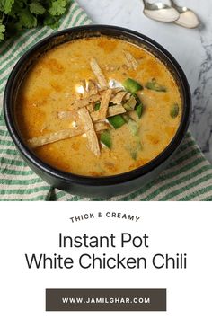 instant pot white chicken chili in a black bowl on a green and white striped napkin