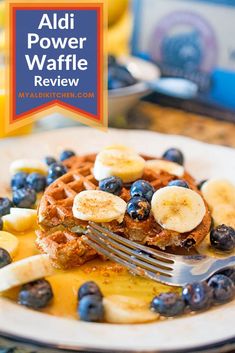 a plate with waffles, bananas and blueberries on it