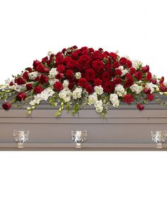 a casket filled with red and white flowers