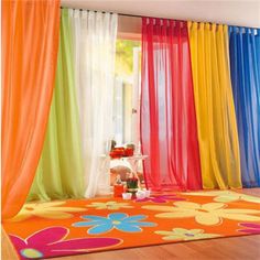 colorful curtains are hanging in front of a window