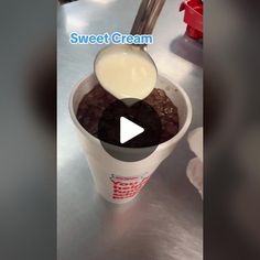 a cup filled with ice cream sitting on top of a table