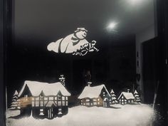 a snow scene is displayed in the window of a building with santa's sleigh on it