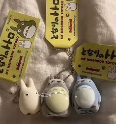 three keychains are shown with different animals on them