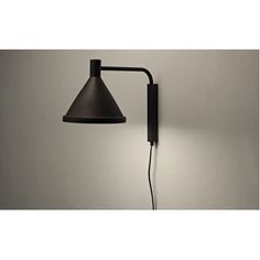 a wall light with a black shade on it