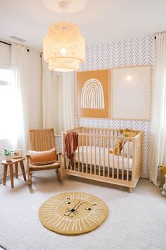 a baby's room with a crib, rocking chair and rug in it