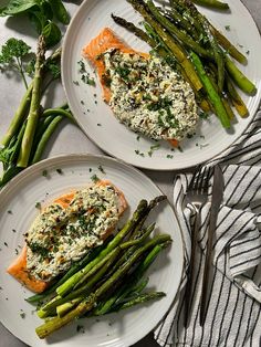 two white plates topped with salmon and asparagus