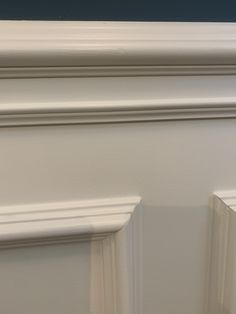 the corner of a wall with white paint and molding on it's edges