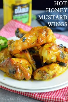 a white plate topped with chicken wings covered in sauce