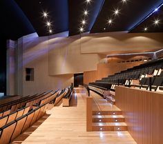 an empty auditorium with rows of seats and lights