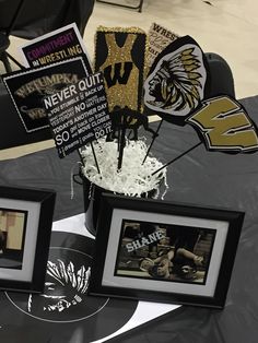 a table topped with pictures and decorations on top of a black cloth covered tablecloth