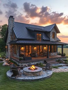 a house with a fire pit in the middle of it and lots of grass around it