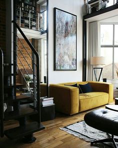 a living room filled with furniture and a spiral staircase