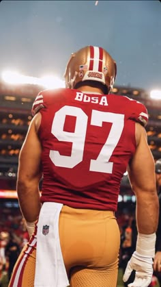 the back of a football player with his hands on his hips