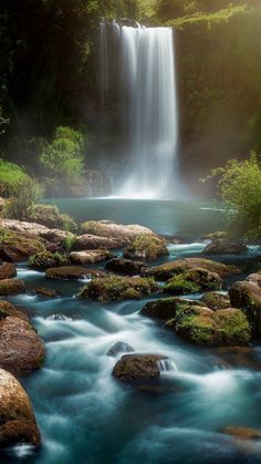 a beautiful waterfall in the middle of a forest