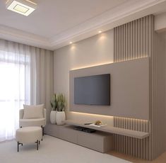 a living room with a flat screen tv mounted on the wall next to a white chair