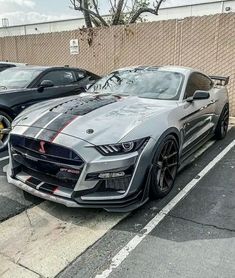 two cars parked next to each other in a parking lot