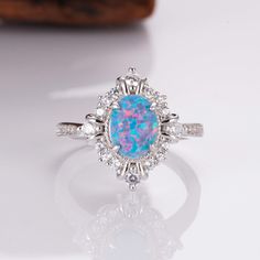 Blue fire opal ring with sterling silver band and crystals Glowing Centerpieces, Birth Stone Jewelry, Lotus Engagement Ring, Ring Around The Rosie, Blue Fire Opal, Jewelry To Buy, Princess Jewelry, Cute Engagement Rings, Fire Opal Ring