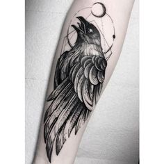 a black and white tattoo with a bird on it's arm, next to the moon