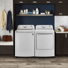 a white washer and dryer sitting next to each other in a laundry room