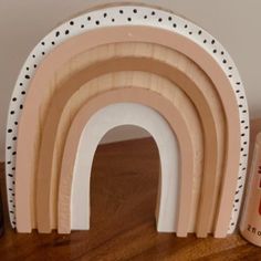 there is a wooden arch with polka dots on it next to a can of soda