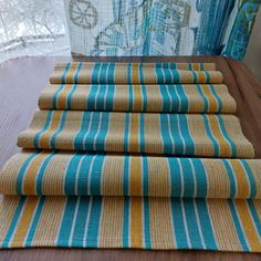 four folded towels sitting on top of a wooden table