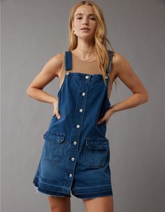 Utility Overalls With Button Closure, Denim Blue Buttoned Overalls For Spring, Denim Blue Overalls With Buttons For Spring, Spring Denim Blue Overalls With Buttons, Utility Cotton Denim Jumpsuit With Button Closure, Cotton Utility Denim Jumpsuit With Button Closure, Utility Denim Button-up Jumpsuit, Button-up Cotton Denim Jumpsuit, Dark Wash Buttoned Cotton Denim Jumpsuit