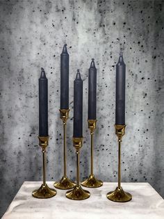 four candles are lined up on a table