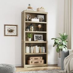 a living room with a couch, chair and bookcase in it's corner