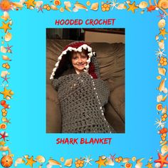 a woman wearing a crochet shark blanket with a hat on her head and the caption hooded crochet