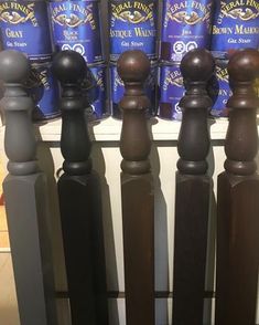 some brown and black railings are next to each other with blue cans in the background