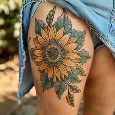 a woman's thigh with a sunflower tattoo on it