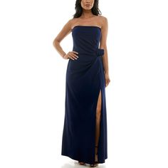 a woman in a strapless blue dress with a slit down the side and her hand on her hip