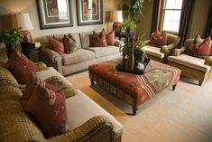 a living room filled with lots of furniture next to a large painting on the wall