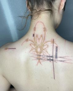 a woman with a tattoo on her back