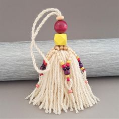 a white tassel with beads and other items on it