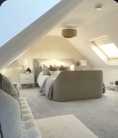 an attic bedroom with white walls and carpeted flooring is pictured in this image